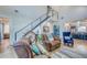 Open-concept living room with staircase and nautical decorations at 6613 Josie Ln, Hudson, FL 34667