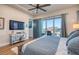 Comfortable main bedroom with a TV, decor, and balcony access, offering a relaxing retreat at 6613 Josie Ln, Hudson, FL 34667