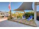Charming outdoor seating area with shade and views of the canal, palm trees, and neighborhood at 6613 Josie Ln, Hudson, FL 34667