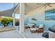 Inviting covered patio features comfortable seating and open access to a waterfront backyard at 6613 Josie Ln, Hudson, FL 34667