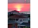 Beautiful sunset view from a rooftop, overlooking nearby houses at 6613 Josie Ln, Hudson, FL 34667
