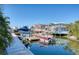 Beautiful waterfront with docks, boat lifts, and calm waters reflecting the surrounding houses at 6613 Josie Ln, Hudson, FL 34667