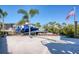 Waterfront property with boat lifts, a picnic area, and lush landscaping on a clear sunny day at 6613 Josie Ln, Hudson, FL 34667
