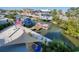 Elevated view of the waterfront canal with docked boats, lush greenery, and nearby homes at 6613 Josie Ln, Hudson, FL 34667
