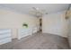 Clean bedroom features carpet, ceiling fan, and a double door closet at 6626 Pine Walk Dr, New Port Richey, FL 34655