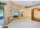 Bright dining room with large windows and chandelier, showcasing a view of the outdoor living space at 6626 Pine Walk Dr, New Port Richey, FL 34655