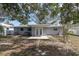 Backyard view showcasing a patio, well-maintained lawn, and a pathway with stepping stones at 686 Manor W Dr, Dunedin, FL 34698
