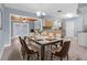 Open dining area with light fixture and french doors to the backyard at 686 Manor W Dr, Dunedin, FL 34698