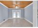A view of the back living area featuring a wood ceiling, tile floors, and french doors at 686 Manor W Dr, Dunedin, FL 34698