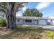 Well-maintained single Gathering home featuring mature landscaping and a cozy front porch at 686 Manor W Dr, Dunedin, FL 34698