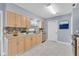 The kitchen features light wood cabinets and a mosaic backsplash at 686 Manor W Dr, Dunedin, FL 34698