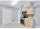 Well-lit kitchen featuring stainless steel appliances, light wood cabinets, and light tile floors at 686 Manor W Dr, Dunedin, FL 34698