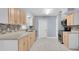 The kitchen features light wood cabinets and stainless steel appliances at 686 Manor W Dr, Dunedin, FL 34698