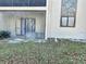 Backyard patio with view of the enclosed porch and landscaped common area at 7109 Kirsch Ct # 2, New Port Richey, FL 34653