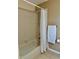 Bathroom featuring a shower with a white shower curtain and tan tiled walls at 7109 Kirsch Ct # 2, New Port Richey, FL 34653
