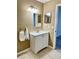 Bathroom featuring a white single sink vanity, framed mirror, and neutral-colored tile flooring at 7109 Kirsch Ct # 2, New Port Richey, FL 34653
