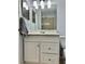 Bathroom features a single sink vanity, updated mirror, and shower with neutral tile at 7109 Kirsch Ct # 2, New Port Richey, FL 34653
