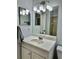 Bathroom features a single sink vanity with a large mirror and shower with neutral tile at 7109 Kirsch Ct # 2, New Port Richey, FL 34653