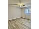 A light-filled bedroom with wood-look flooring and a ceiling fan at 7109 Kirsch Ct # 2, New Port Richey, FL 34653