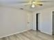 A bedroom with wood-look flooring, ceiling fan and access to closet and doorways at 7109 Kirsch Ct # 2, New Port Richey, FL 34653