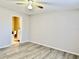 A light-filled bedroom with wood-look flooring adjoins a bathroom at 7109 Kirsch Ct # 2, New Port Richey, FL 34653