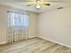 A light-filled bedroom with wood-look flooring and a ceiling fan at 7109 Kirsch Ct # 2, New Port Richey, FL 34653