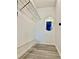 Walk-in closet featuring white walls, wire shelving, and gray laminate flooring at 7109 Kirsch Ct # 2, New Port Richey, FL 34653
