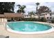 Community pool with lounge chairs and view of the common area and residential buildings at 7109 Kirsch Ct # 2, New Port Richey, FL 34653