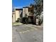 View of the condo building with parking, stone facade, and a two-story layout at 7109 Kirsch Ct # 2, New Port Richey, FL 34653