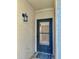Front door of unit number 2 featuring a storm door, lantern and covered entrance at 7109 Kirsch Ct # 2, New Port Richey, FL 34653