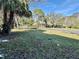 Well-maintained front lawn with mature trees and a view of the community buildings at 7109 Kirsch Ct # 2, New Port Richey, FL 34653