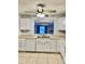 Kitchen with white appliances, cabinets, and a large opening to the living space at 7109 Kirsch Ct # 2, New Port Richey, FL 34653