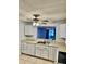 Traditional-style kitchen featuring white cabinets, laminate countertops, and stainless steel sink at 7109 Kirsch Ct # 2, New Port Richey, FL 34653