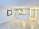 Bright living room featuring tile flooring and a view into the kitchen at 7109 Kirsch Ct # 2, New Port Richey, FL 34653