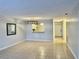 Living room featuring neutral walls, tile floors, and access to dining and front door at 7109 Kirsch Ct # 2, New Port Richey, FL 34653