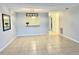 Bright living room featuring tile flooring and a view into the kitchen at 7109 Kirsch Ct # 2, New Port Richey, FL 34653
