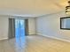 Spacious living room featuring neutral walls, tile flooring, and natural light at 7109 Kirsch Ct # 2, New Port Richey, FL 34653
