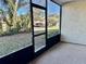 Enclosed porch with outdoor view of landscaped yard and community parking at 7109 Kirsch Ct # 2, New Port Richey, FL 34653