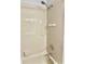 Shower features neutral tile with updated shower head and faucet hardware at 7109 Kirsch Ct # 2, New Port Richey, FL 34653