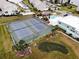 A bird's eye view showcases two tennis courts, a putting green, and a community pool near the waterfront at 8150 Brent St # 713, Port Richey, FL 34668