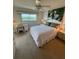 Comfortable bedroom with water views, desk, ceiling fan, and natural light at 8150 Brent St # 713, Port Richey, FL 34668