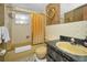 Bathroom with classic fixtures, a framed mirror, a yellow sink, and a bathtub featuring a shower with a curtain at 8715 Robilina Rd, Port Richey, FL 34668