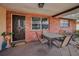 Inviting front porch with brick detail, a decorative front door, outdoor seating, and a view of the neighborhood at 8715 Robilina Rd, Port Richey, FL 34668