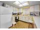 Classic kitchen with white cabinets, vintage tile floor and stainless steel appliances at 8715 Robilina Rd, Port Richey, FL 34668