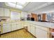 Bright kitchen with ample counter space, white cabinets, and open layout to the living area at 8715 Robilina Rd, Port Richey, FL 34668