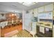 Efficient kitchen with white appliances, a view to the dining room and access to the stove at 8715 Robilina Rd, Port Richey, FL 34668