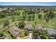 Aerial view of homes backing onto a lush green golf course with mature trees at 8788 Fetterbush Ct, Brooksville, FL 34613