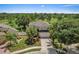 Daytime aerial shot of the home featuring lush landscaping, a two-car garage, and golf course views at 8788 Fetterbush Ct, Brooksville, FL 34613