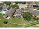 Real estate aerial view featuring spacious backyard with lawn, trees, and playground at 8788 Fetterbush Ct, Brooksville, FL 34613