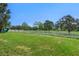 The fenced backyard has a playset and manicured lawn at 8788 Fetterbush Ct, Brooksville, FL 34613